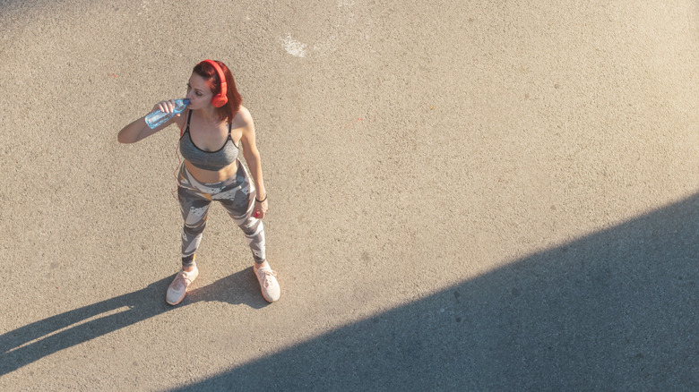 Woman drinking while exercising