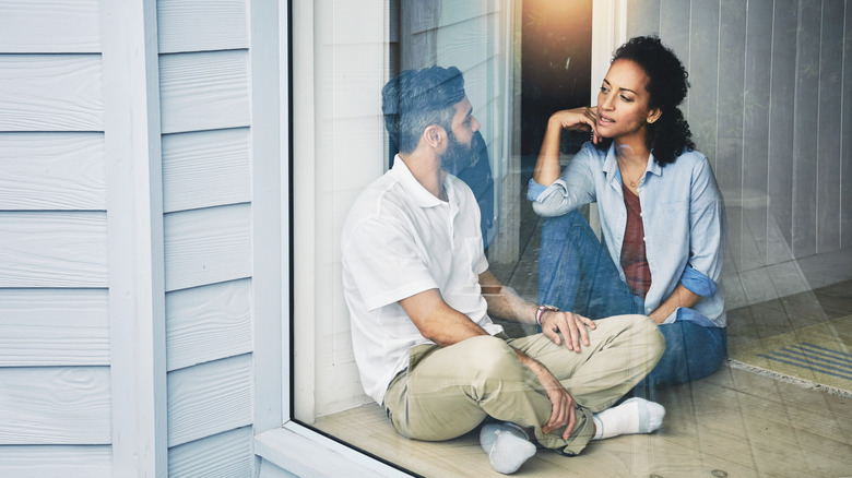 Couple talking photo taken through a window