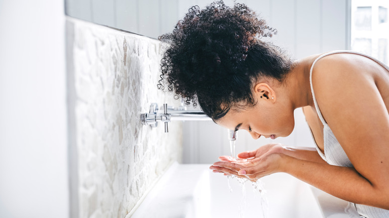 Woman cleansing her face