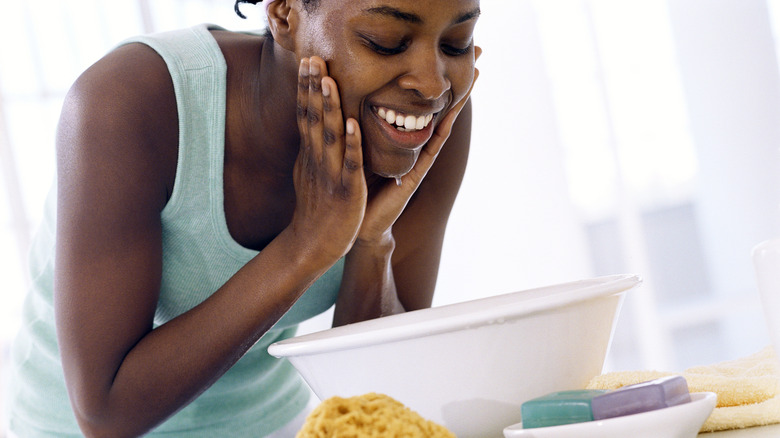 woman washes face