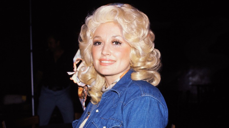 Young Dolly Parton with a curly blond wig