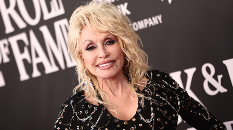 Dolly Parton  smiling with her signature blond wig