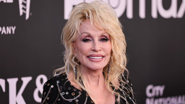 Dolly Parton smiles on the red carpet in 2022