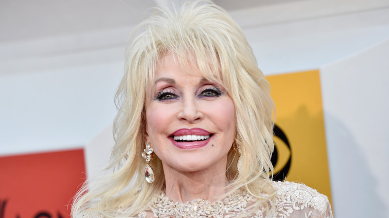 Dolly Parton smiles on the red carpet in 2016