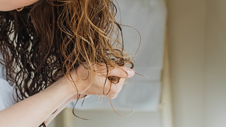 Woman scrunching mousse into hair