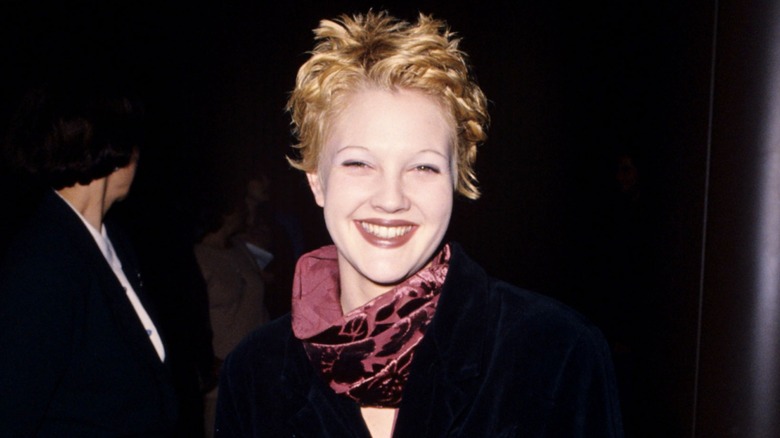 Drew Barrymore smiling with short hair in 1995.
