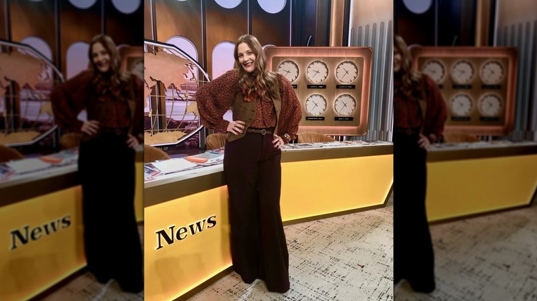 Drew Barrymore pising in '70s-inspired trousers and vest