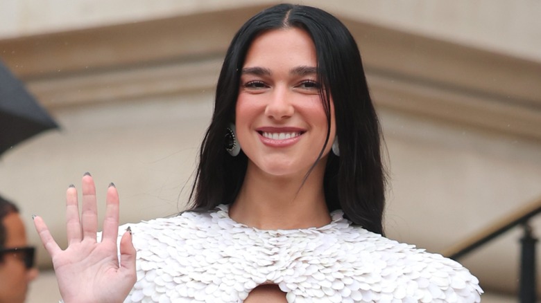 Dua Lipa waving and smiling