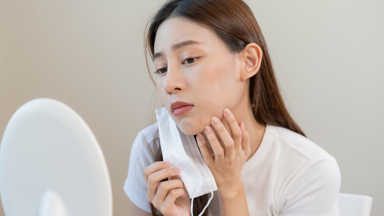 Woman examining blemishes