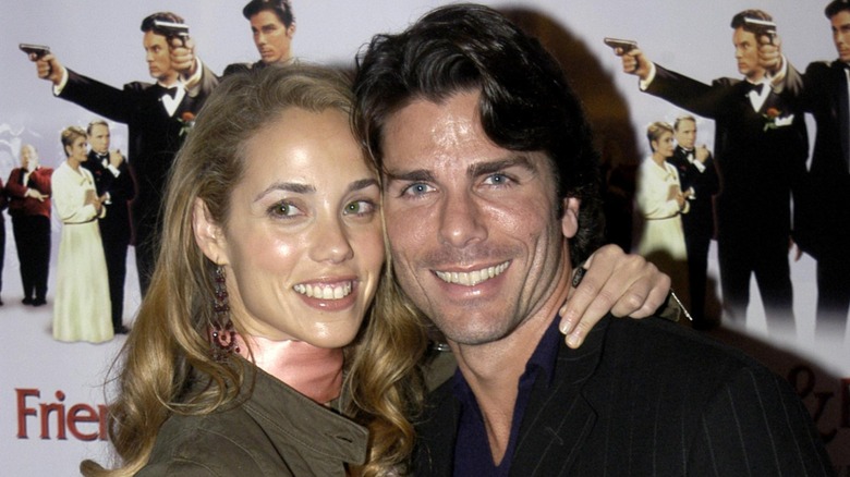 Elizabeth Berkley and Greg Lauren posing on the red carpet in 2003