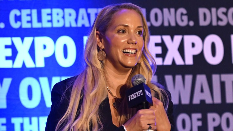 Elizabeth Berkley speaking on stage in 2024