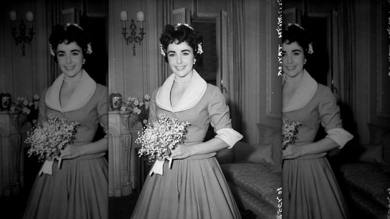Elizabeth Taylor wearing a tea skirt and suit jacket on the day of her wedding to Michael Wilding