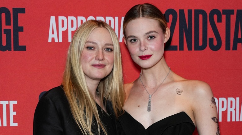 Dakota Fanning and Elle Fanning posing on the red carpet together in 2023