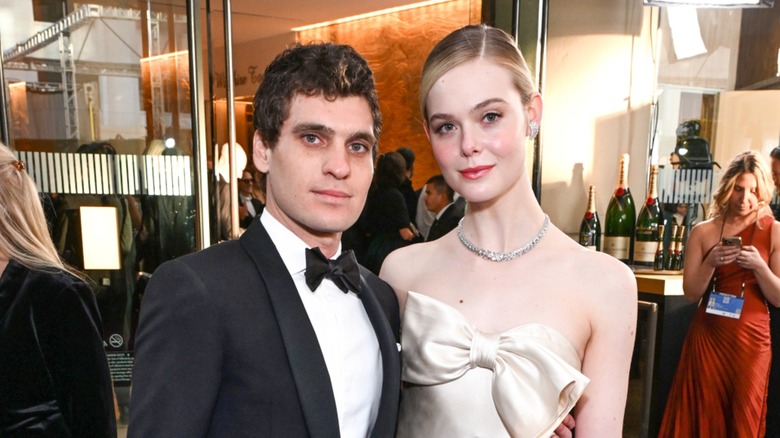 Elle Fanning posing on the red carpet with Gus Wenner in 2024
