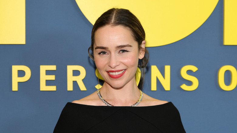 Emilia Clarke on the red carpet with brown hair