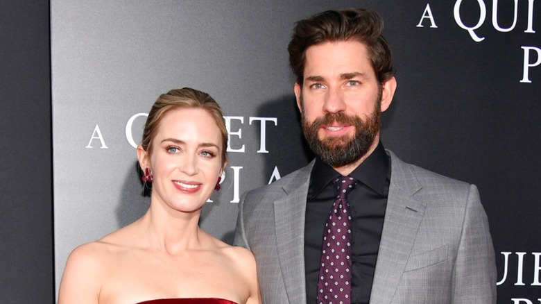 Emily Blunt and John Krasinski posing together on the red carpet at the premiere of A Quiet Place