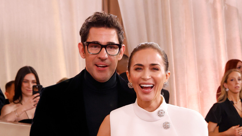 Emily Blunt and John Krasinski smile on the red carpet in 2026