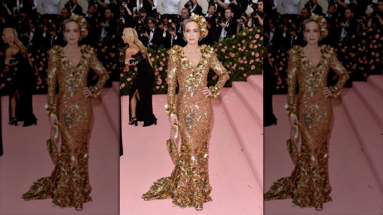 Emily Blunt poses in an embellished golden dress.