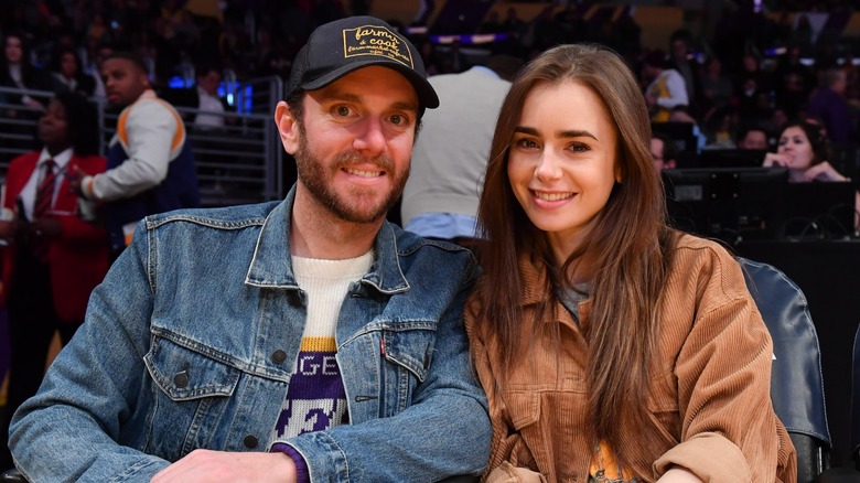 Charlie McDowell and Lily Collins at a basketball game in 2020