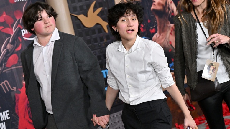 Emme Muniz holding hands with a friend on the red carpet