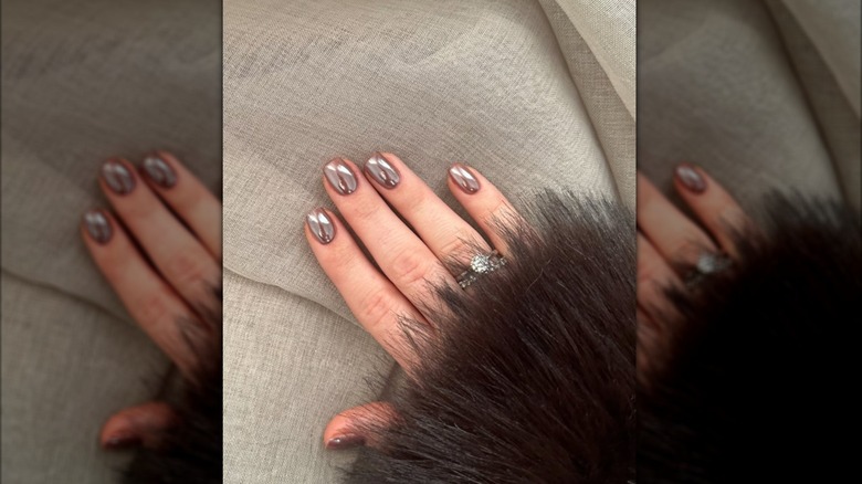 A hand with soft shimmery brown nails