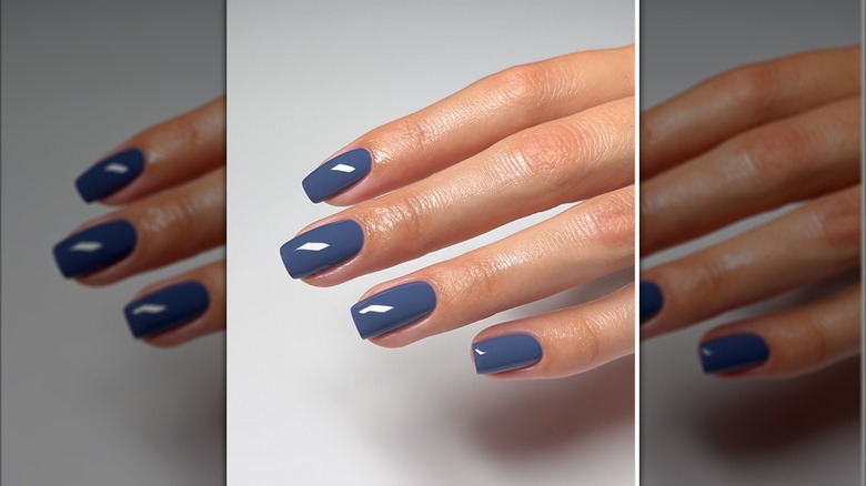 A woman with a denim blue nail polish on