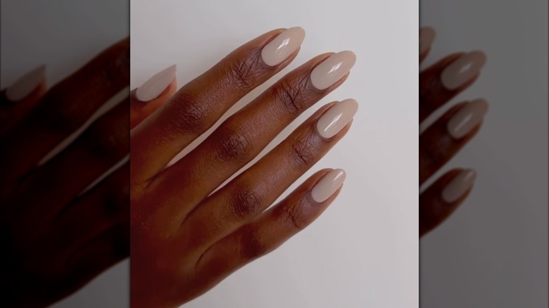 A woman wearing Dunes manicure color