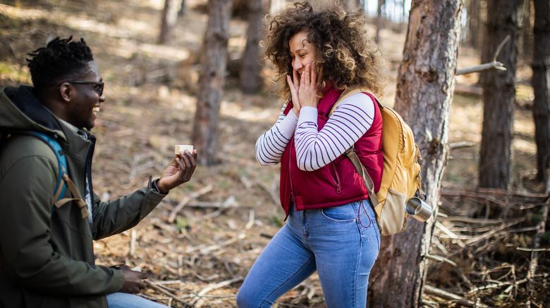Man proposing to woman in the wilderness