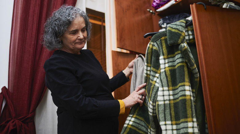 Woman examining closet