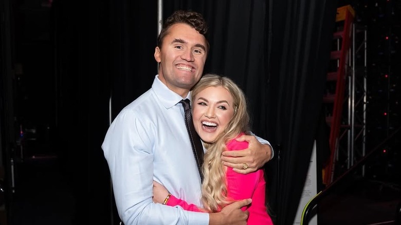 Charlie Kirk and Erika Kirk smile while they embrace