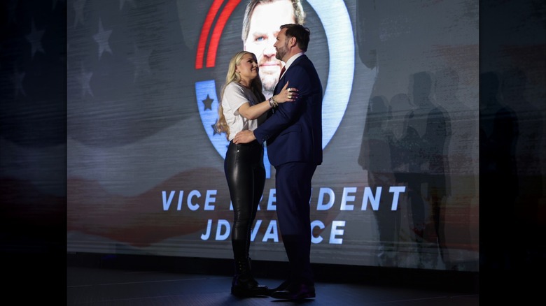 Erika Kirk in leather pants hugging JD Vance on stage