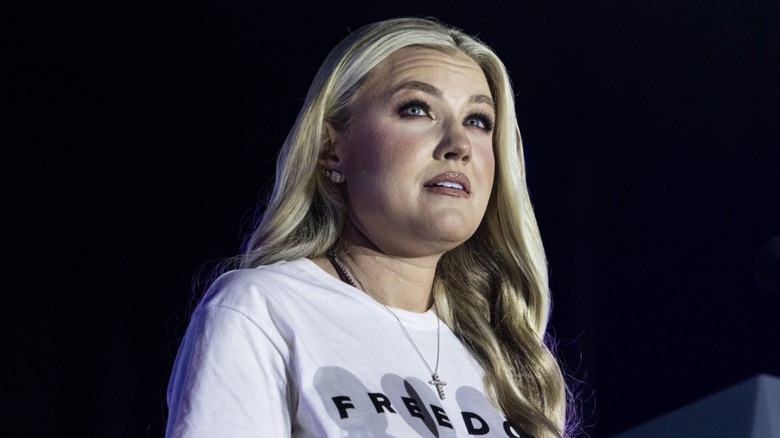 Erika Kirk speaking on stage in 2025