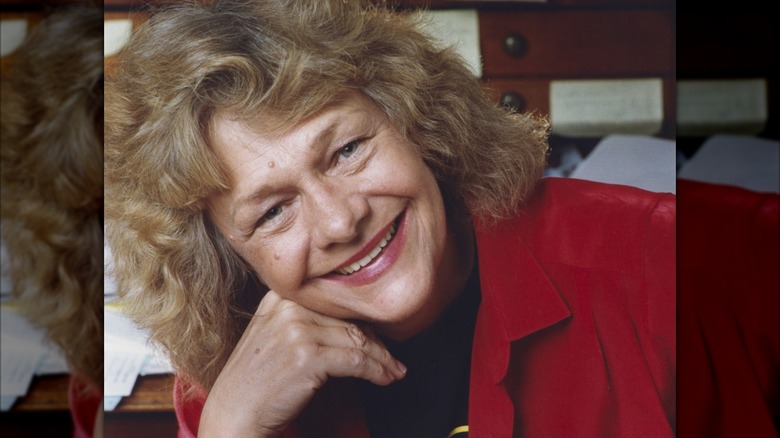 Estelle Parsons smiling while resting her head on her hand in the early '90s