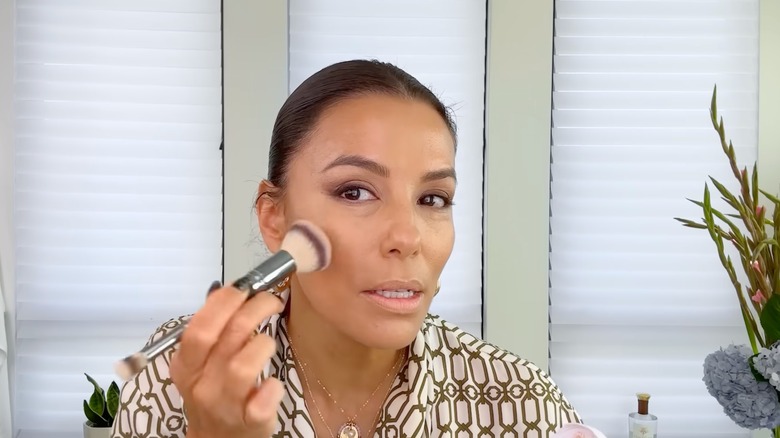 Eva Longoria applying bronzer during beauty routine tutorial video for Vogue