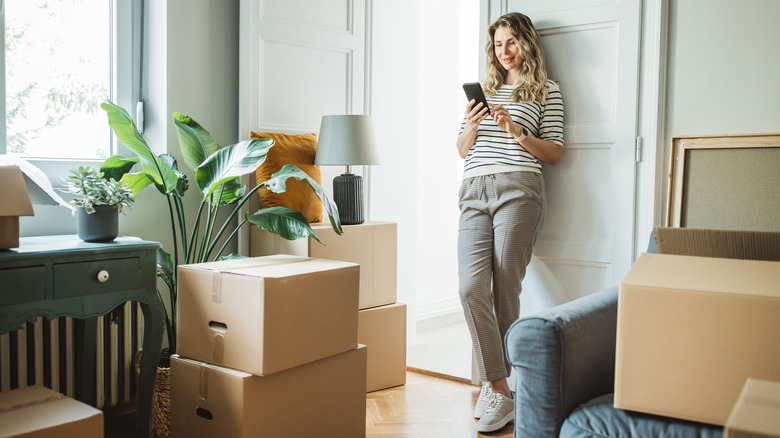 Woman moving in, leaning against door