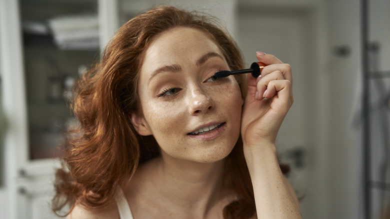 woman applying mascara