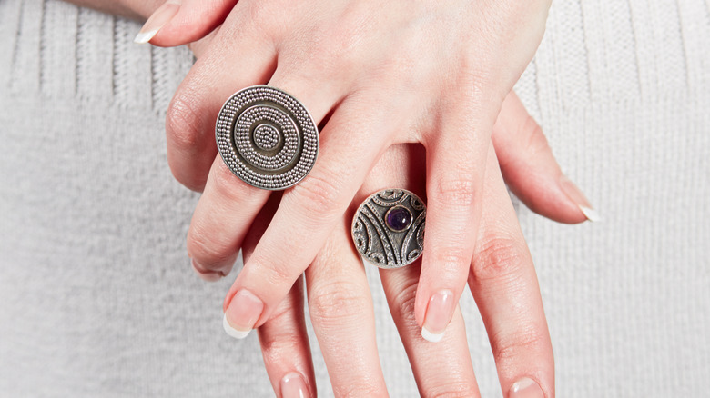 woman's hands signet rings