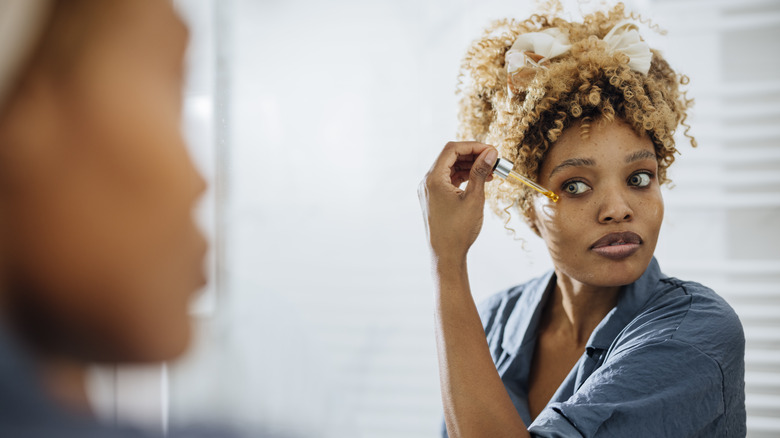 Woman applying serum