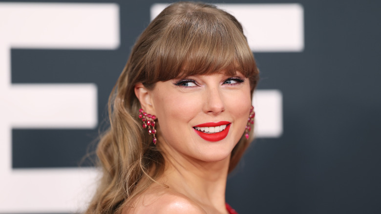 Taylor Swift smiles on the red carpet in 2025