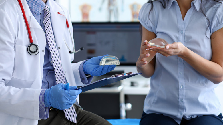 Surgeon and patient holding implants