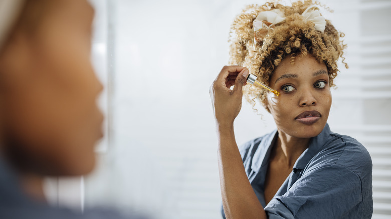 Woman using face serum