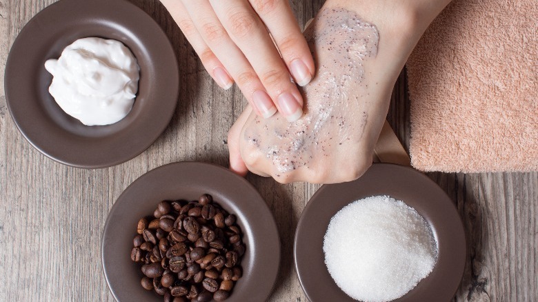 Woman applying coffee scrub