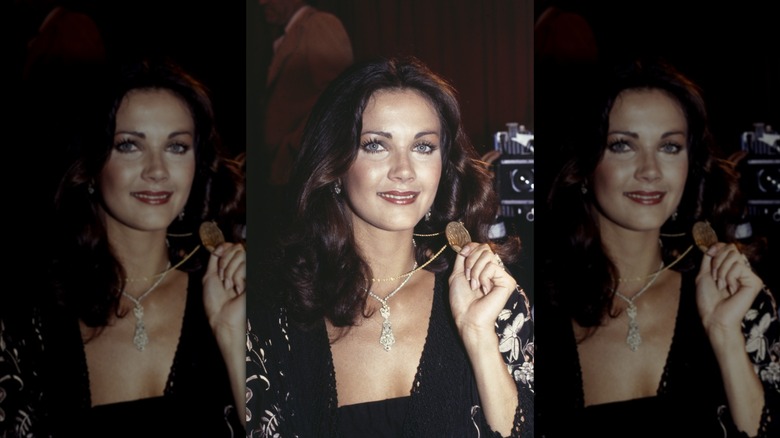 Lynda Carter smiles wearing a cherry-red lipstick and subtle under-eyeliner