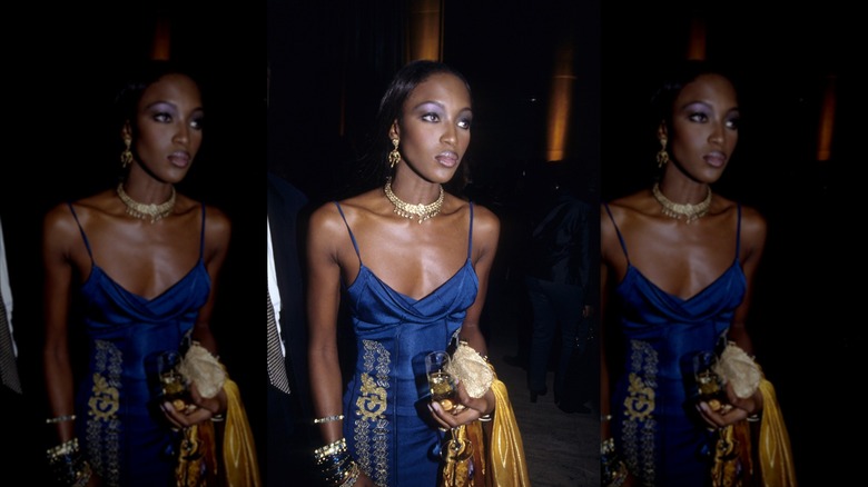 Naomi Campbell wearing a blue dress and a frosted makeup look