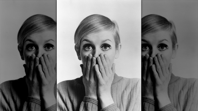 Twiggy poses wearing bold eyeliner and fake eyelashes