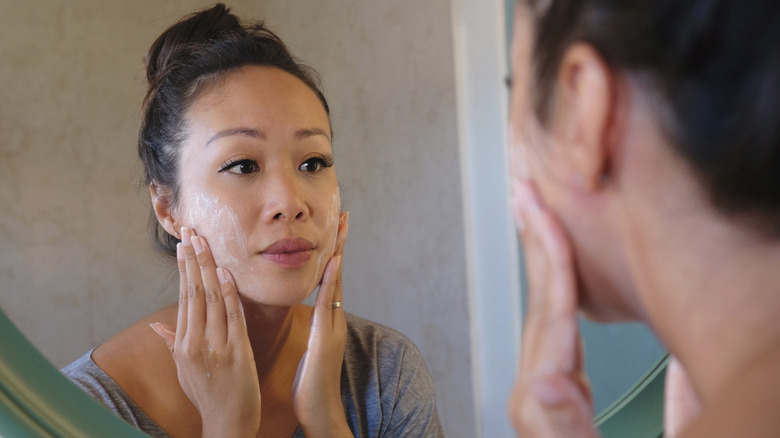 Woman touching her face