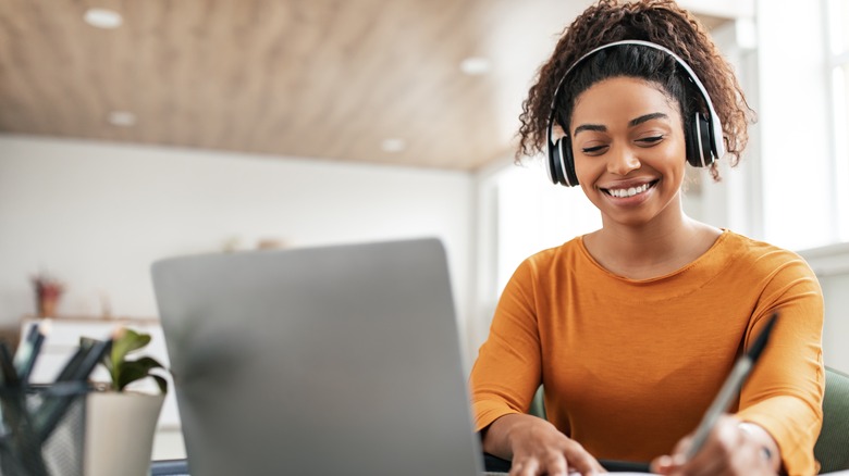 woman wearing headphones and smiling 
