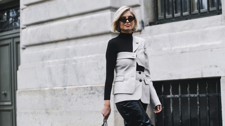 Woman in jacket and sunglasses on street