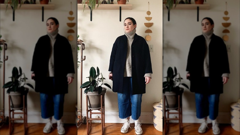 A woman on Instagram in a black, oversized coat and jeans
