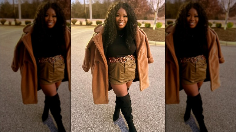 A woman on Instagram wearing a brown jacket and a statement belt